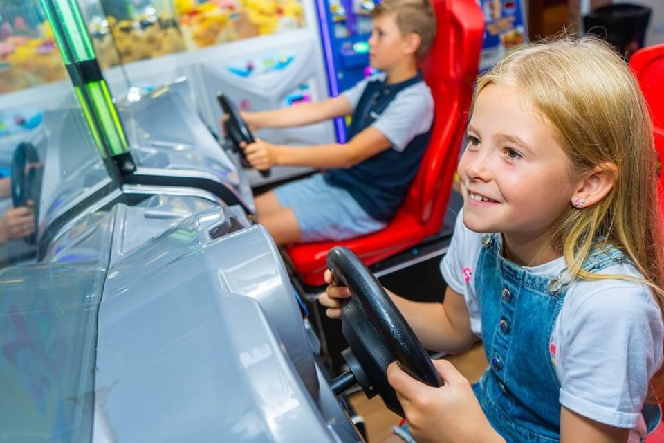 kids playing on arcade machines