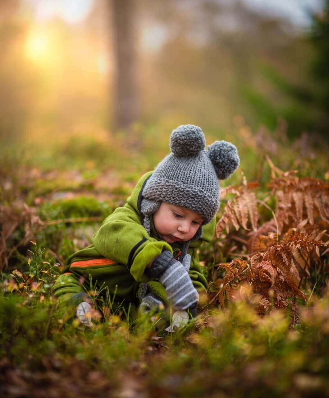 Cute baby exploring the winter woodland
