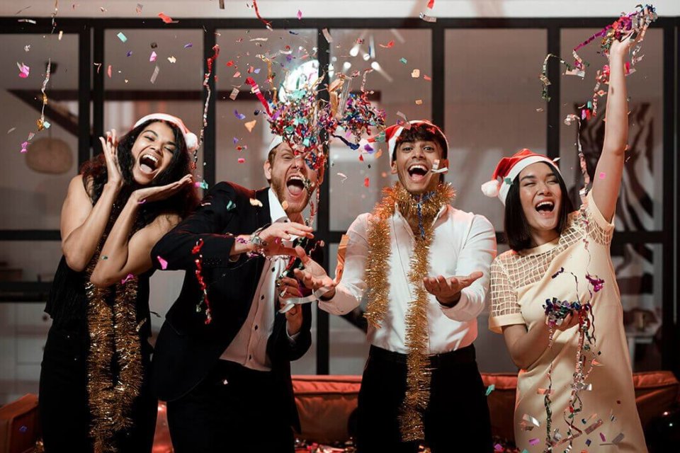 A group of young adults celebrating at their Christmas Party