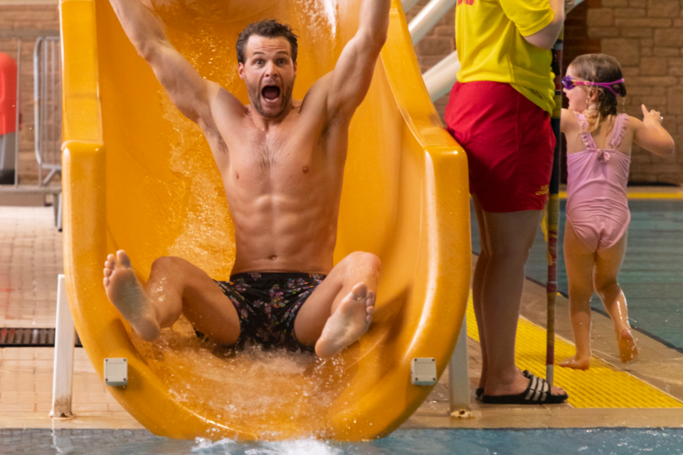 A screaming man going down the indoor pool slide at Lady's Mile
