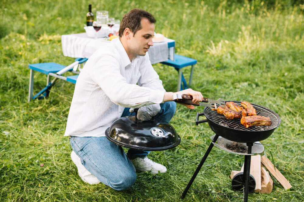 Holiday park BBQ safety - campers grilling safely.