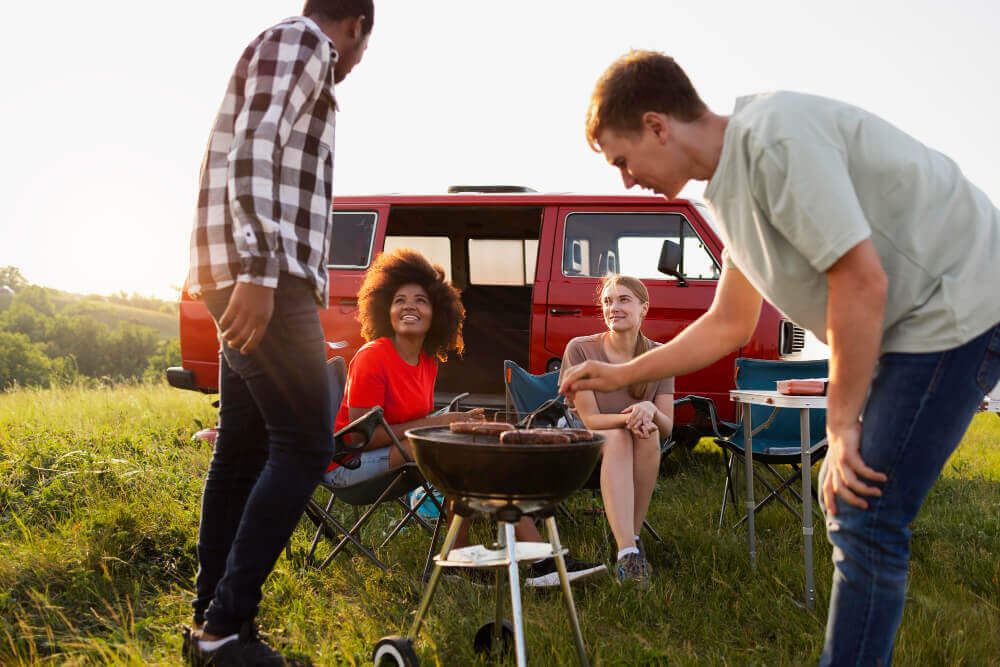 Holiday park BBQ safety - friends enjoying a safe BBQ.