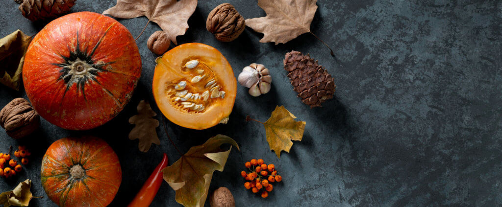 An assortment of pumpkins, spices and leaves