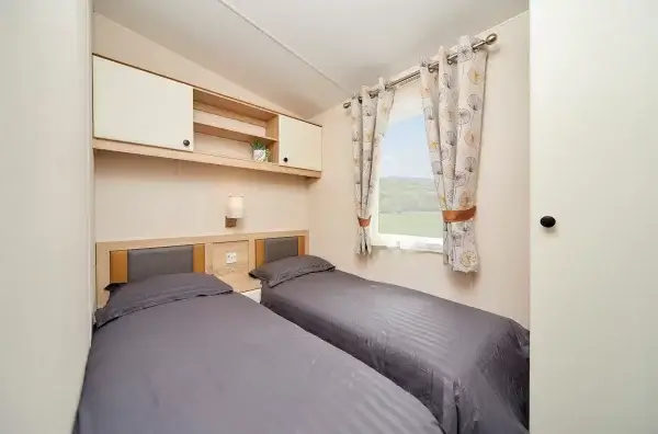 Two single beds in a twin caravan bedroom