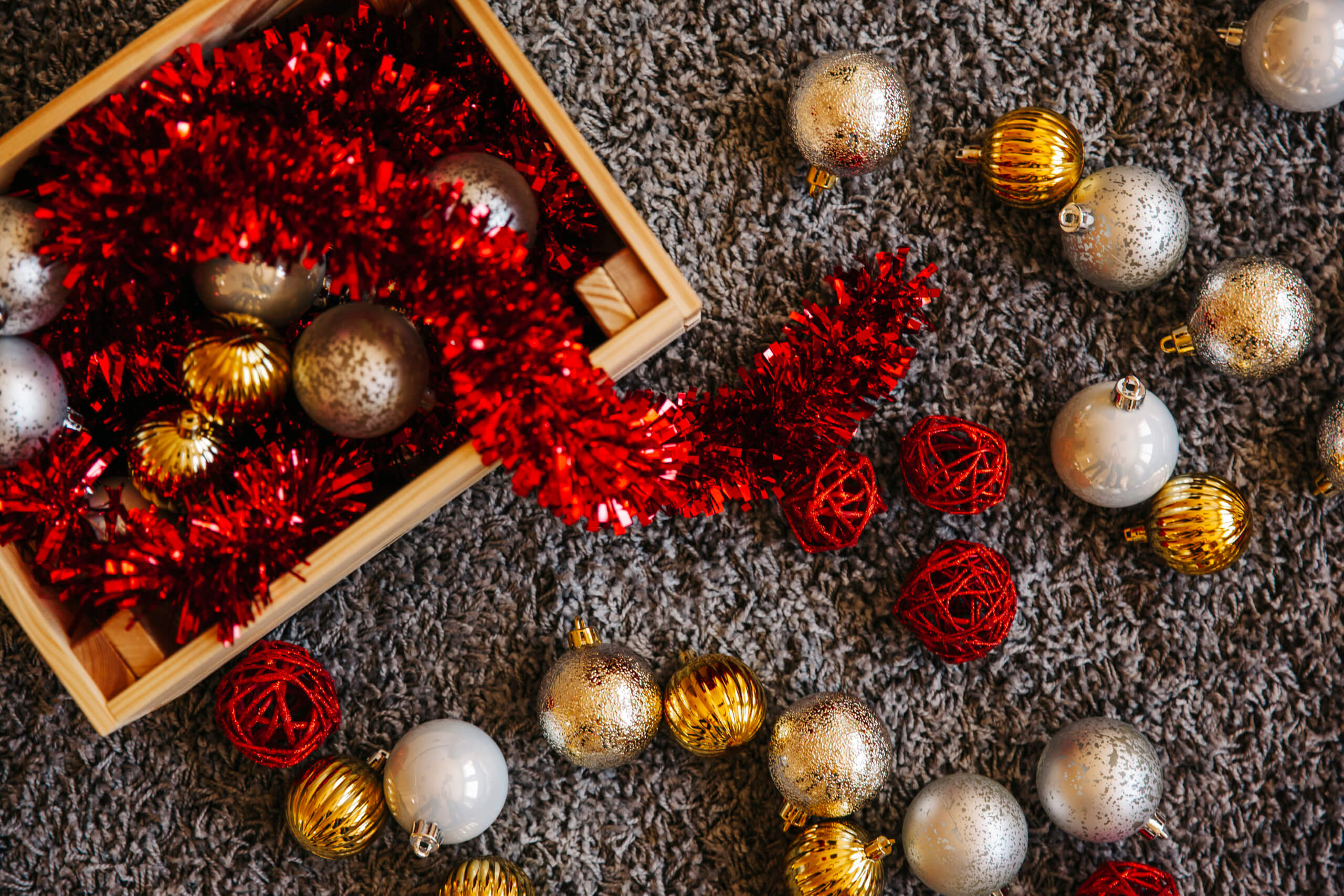 Christmas baubles and tinsel in a wooden box