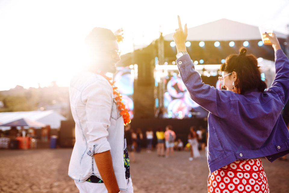 Couple with beer at music festival.