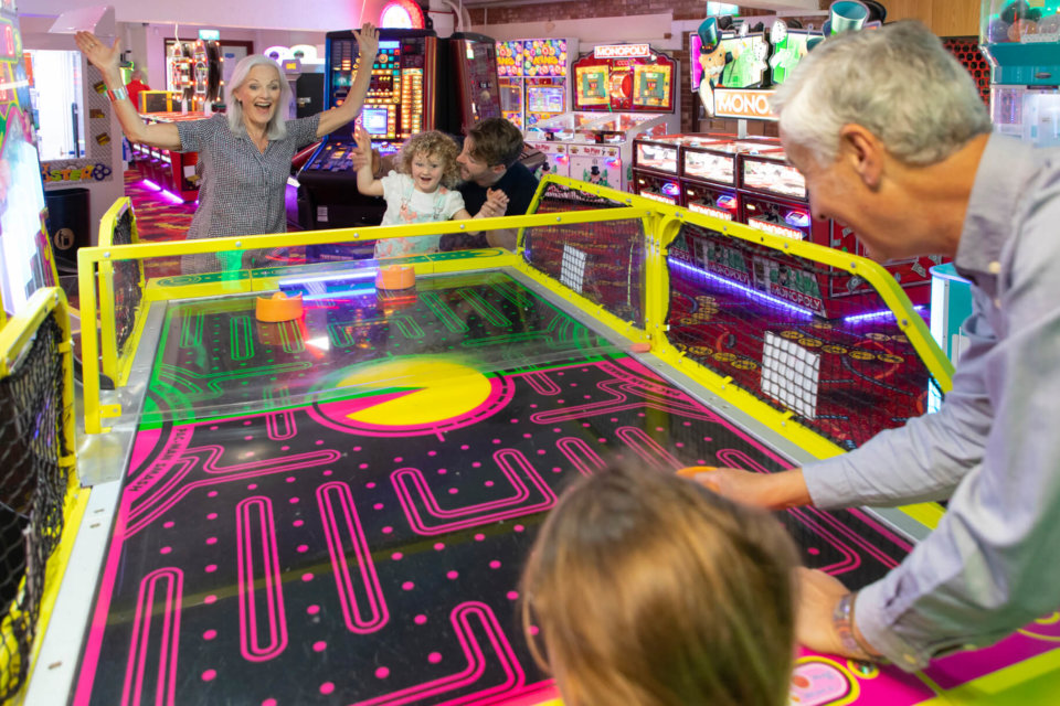 Family playing games in an arcade