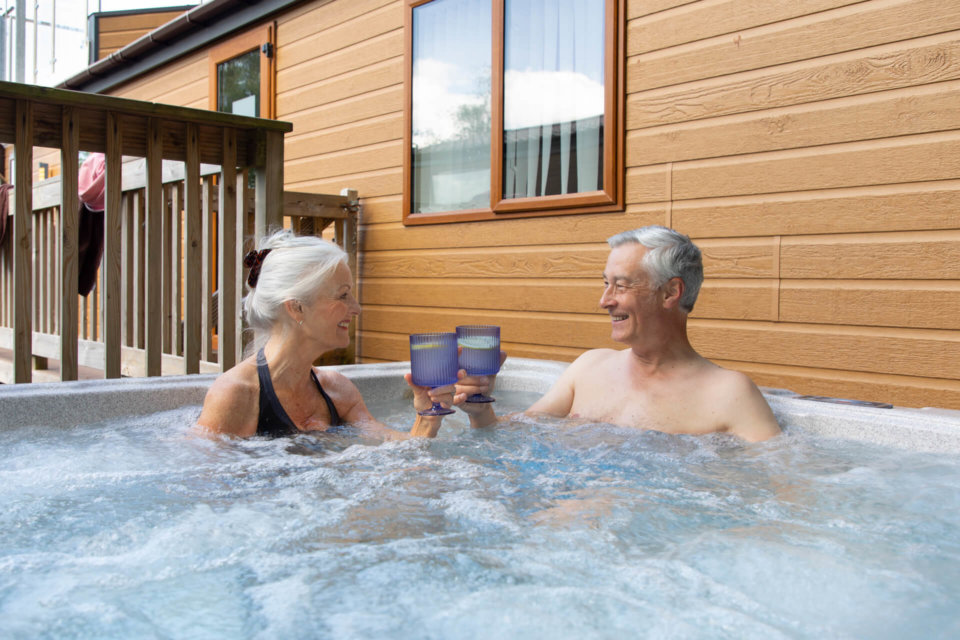Elderly couple with purple glasses in a hot tub