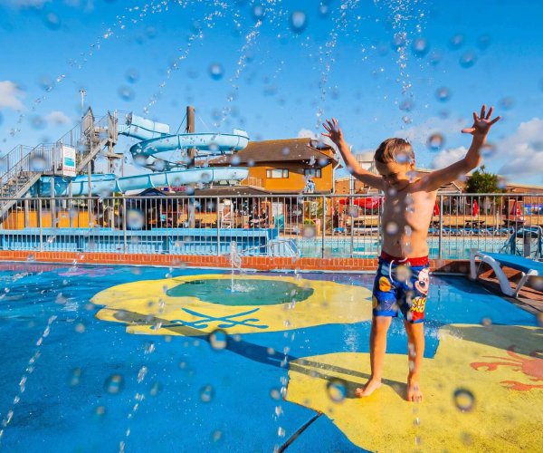 A young boy playing in the Lady's Mile splash park